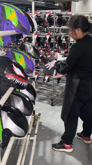 QC inspector checking motorcycle helmet appearance and craftsmanship